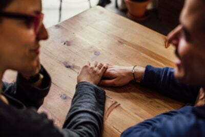 a man and a woman looking at a wooden table