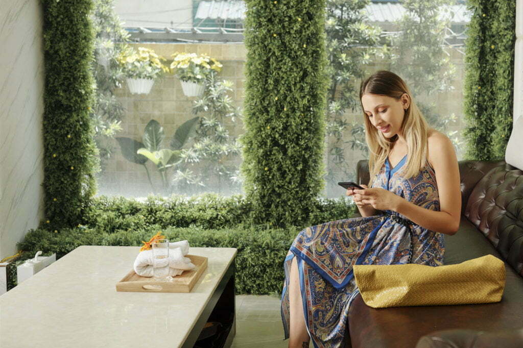 a person sitting on a couch looking at a phone