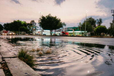 Water gushing out of road storm drain