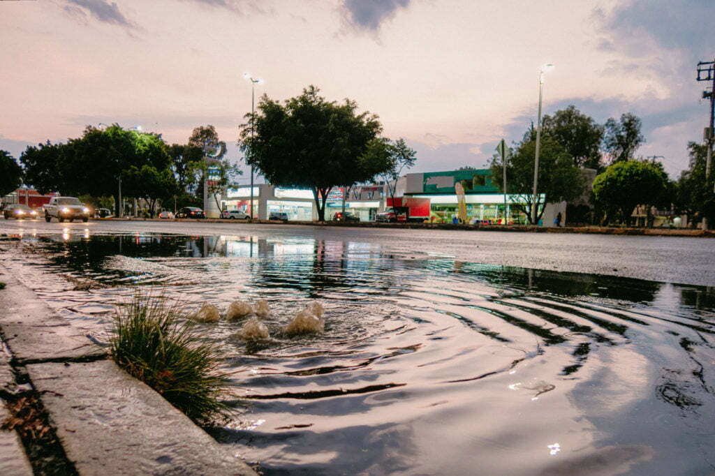 Water gushing out of road storm drain